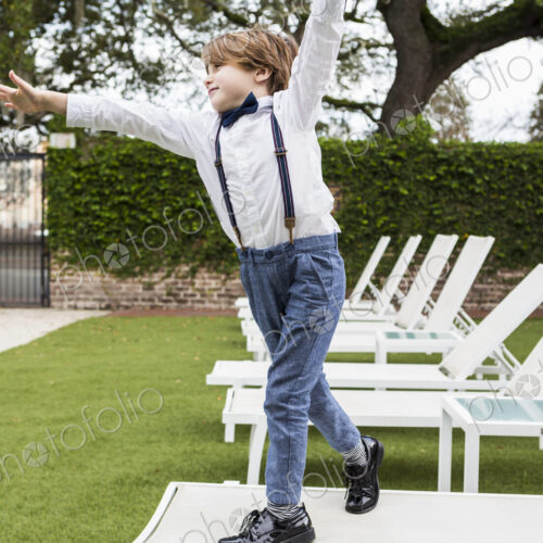 6 year old boy standing on lawn chair
