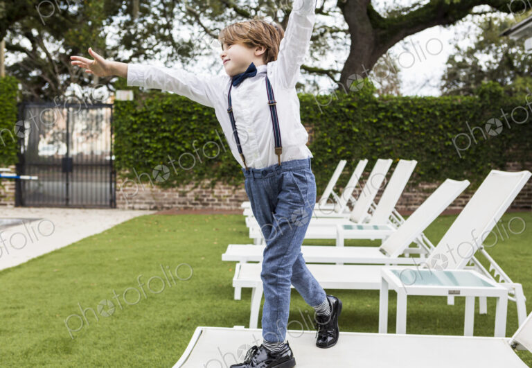 6 year old boy standing on lawn chair