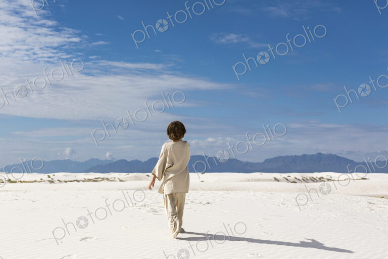 6 year old boy walking in sand dnes.