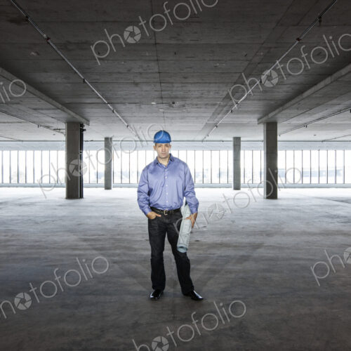 A Caucasian male architect in a new raw business space.