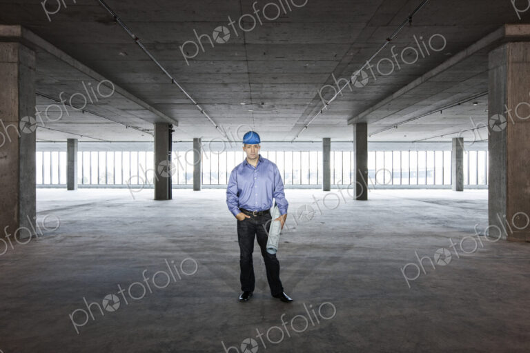 A Caucasian male architect in a new raw business space.