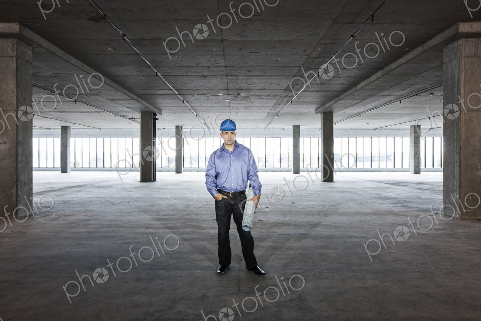 A Caucasian male architect in a new raw business space.