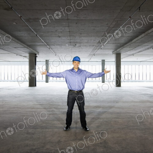 A Caucasian male architect in a new raw business space.