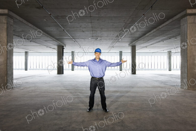 A Caucasian male architect in a new raw business space.