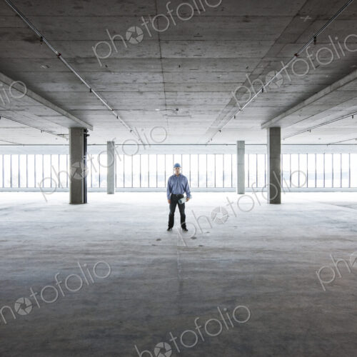 A Caucasian male architect in a new raw business space.