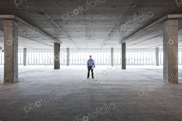 A Caucasian male architect in a new raw business space.