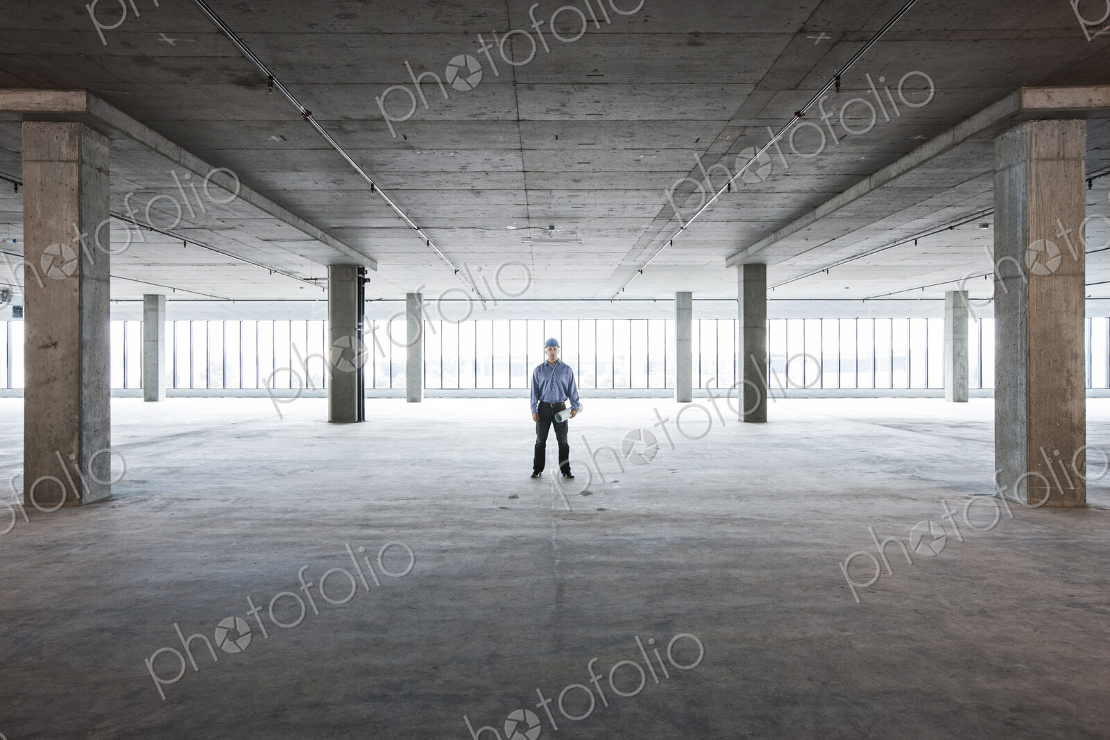 A Caucasian male architect in a new raw business space.