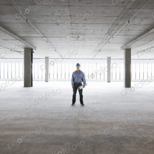 A Caucasian male architect in a new raw business space.