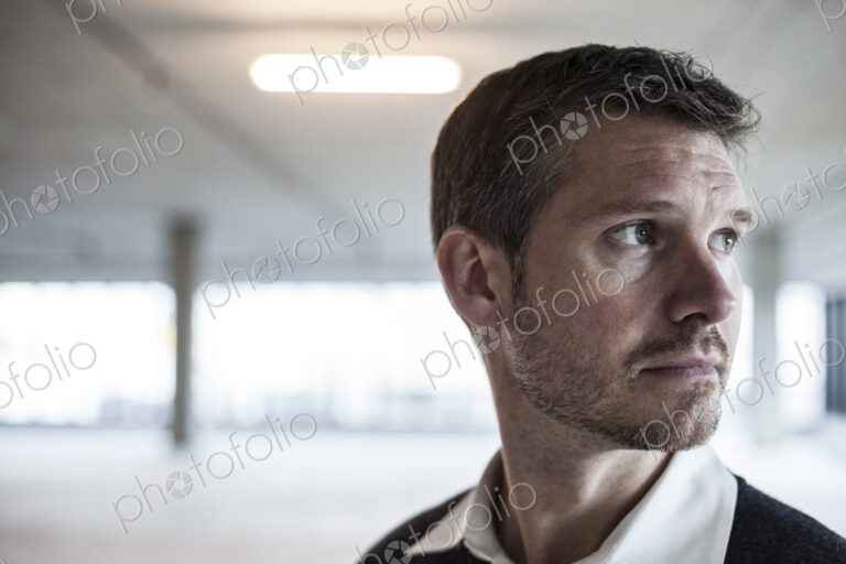 A Caucasian male architect in a new raw business space.