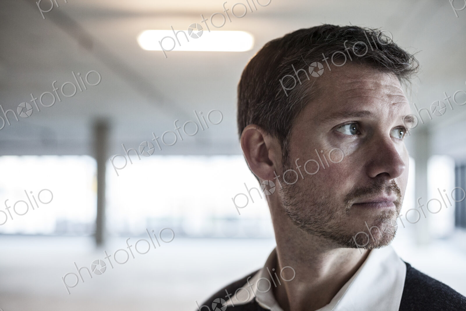 A Caucasian male architect in a new raw business space.