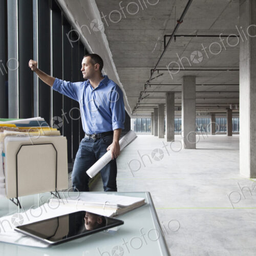 A Caucasian man at his temporary desk, in a new raw business space. A Caucasian man at his temporary desk, in a new raw business space.