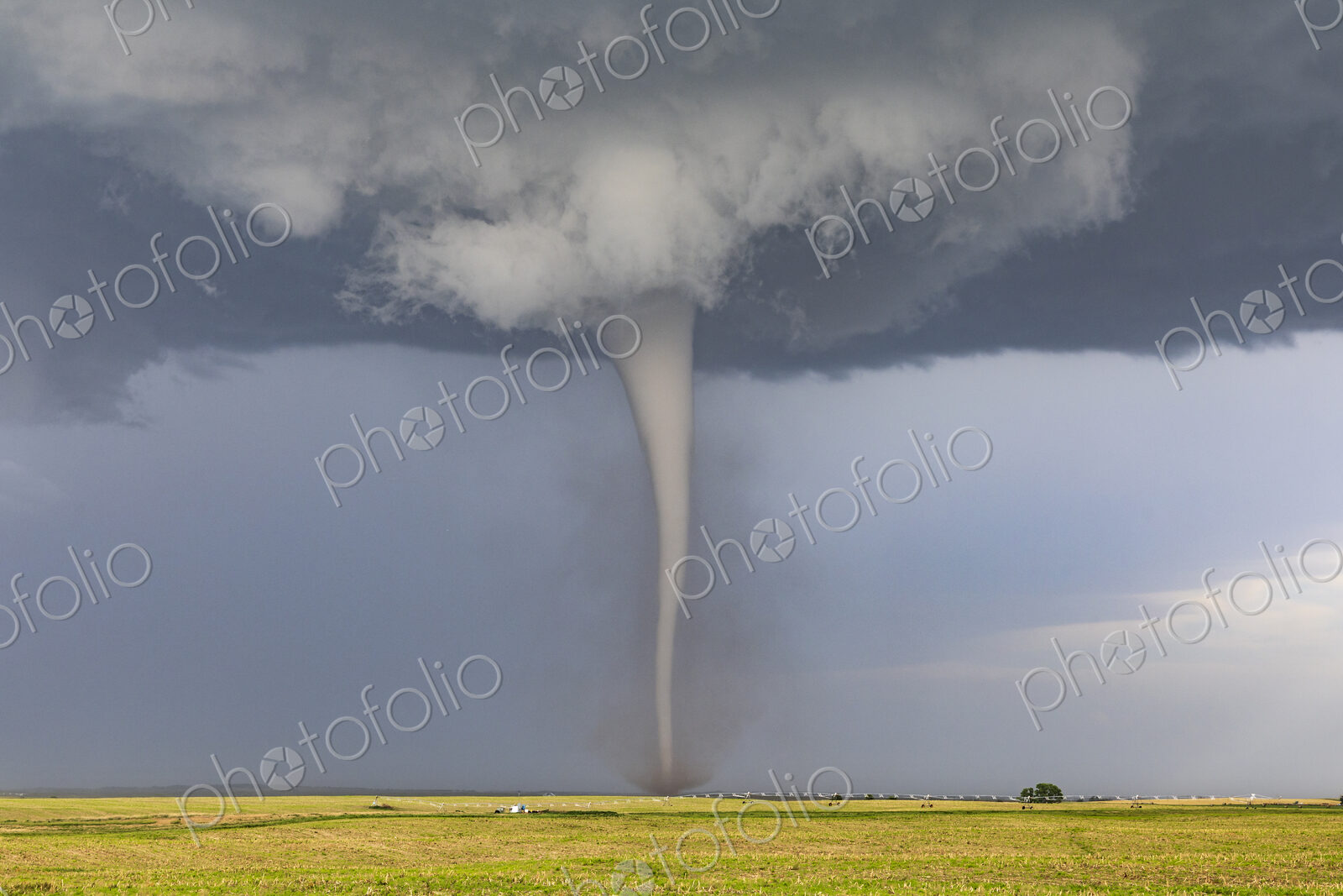A Condensed Tornado, a rotating column of air reaching to the ground, a defined shape.