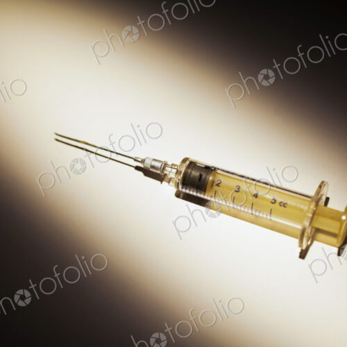 A Medical Syringe. studio shot of an object in a pool of light.
