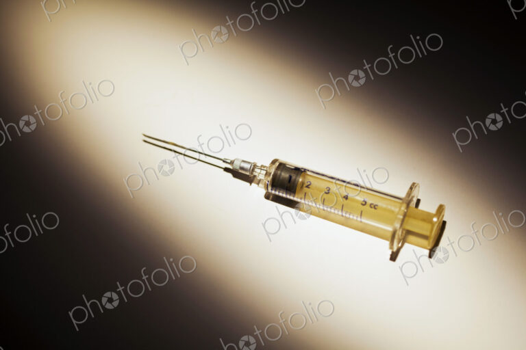 A Medical Syringe. studio shot of an object in a pool of light.