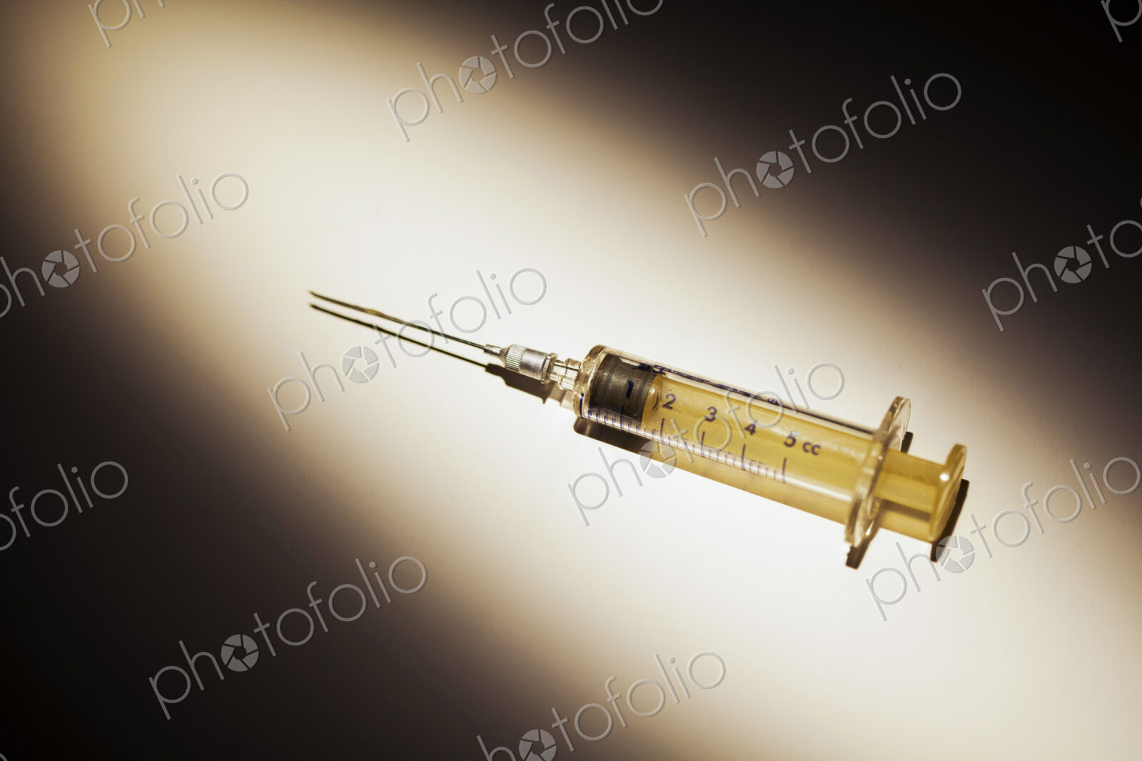 A Medical Syringe. studio shot of an object in a pool of light.