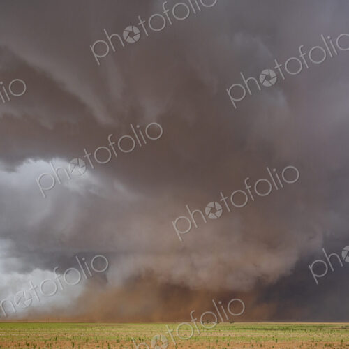 A Monster Wedge Tornado near Morton, clouds gathering in the sky above fields in a…