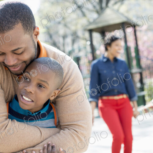 A New York city park in the spring. A family, parents and two boys spending time… A New York city park in the spring. A family, parents and two boys spending time…