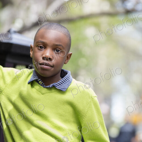 A New York city park in the spring. Sunshine and cherry blossom. A boy in a green… A New York city park in the spring. Sunshine and cherry blossom. A boy in a green…