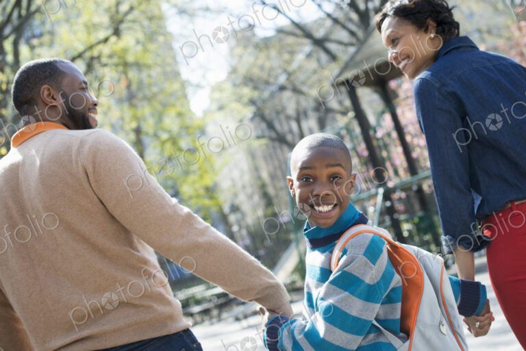A New York city park in the spring. Sunshine and cherry blossom. A boy looking over…