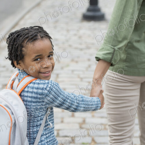 A New York city park in the spring. Sunshine and cherry blossom. A boy wearing a…