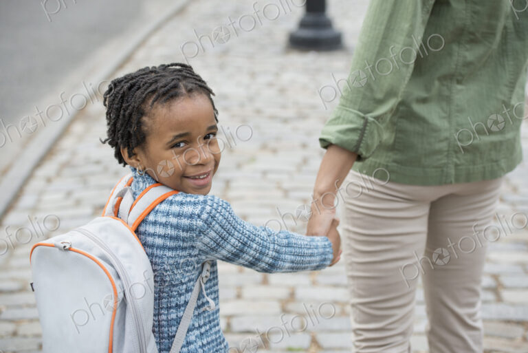 A New York city park in the spring. Sunshine and cherry blossom. A boy wearing a…