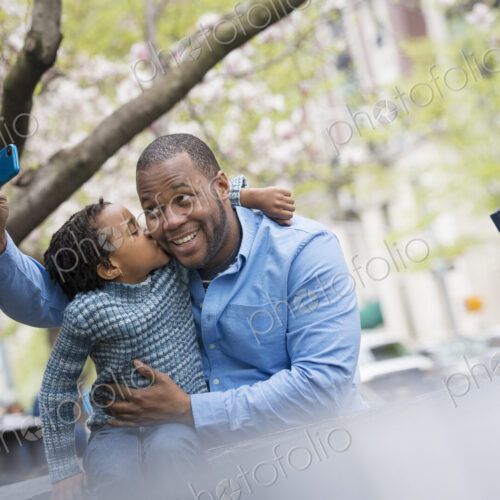 A New York city park in the spring. Sunshine and cherry blossom. A father and son side… A New York city park in the spring. Sunshine and cherry blossom. A father and son side…