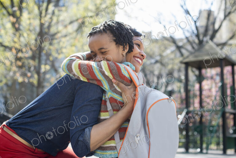 A New York city park in the spring. Sunshine and cherry blossom. A mother and son…