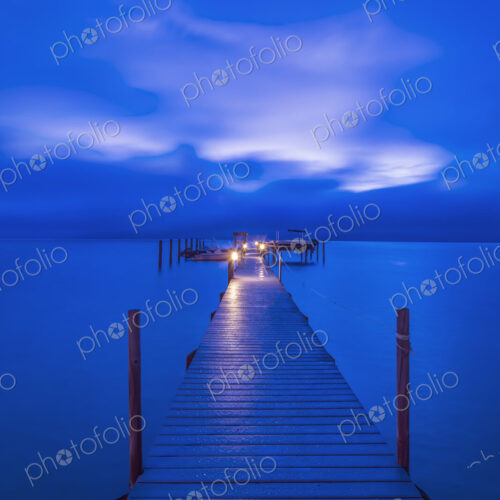 A Private Dock at Dawn, view along the walkway to the lights at the end, stretching… A Private Dock at Dawn, view along the walkway to the lights at the end, stretching…