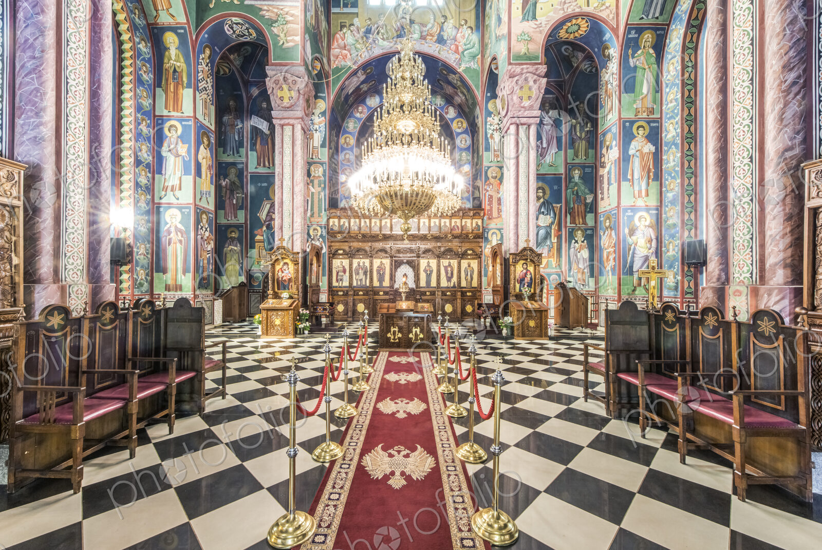 A Serbian Orthodox church interior in Ljublijana, murals, painted pillars and walls,…