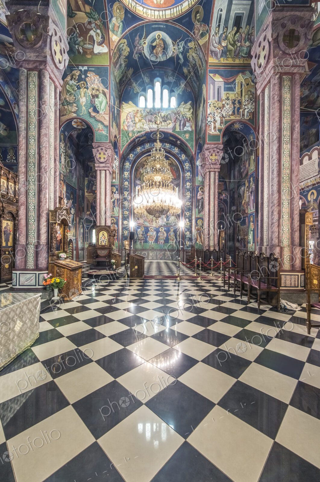 A Serbian Orthodox church interior in Ljublijana, murals, painted pillars and walls,…