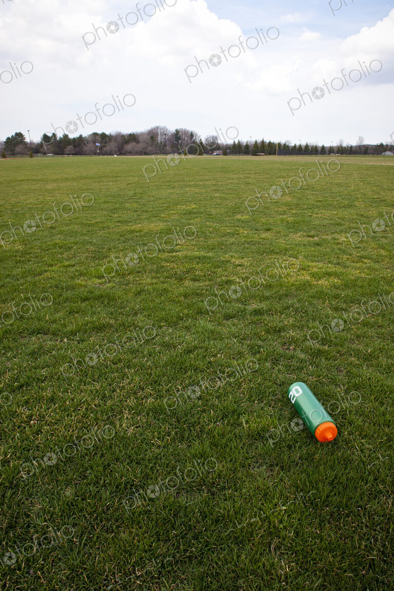 A Water Bottle on a Sports Field