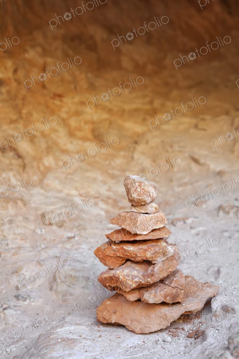 A balanced stack of red and orange sandstone rocks forms a small cairn in Bryce Canyon…