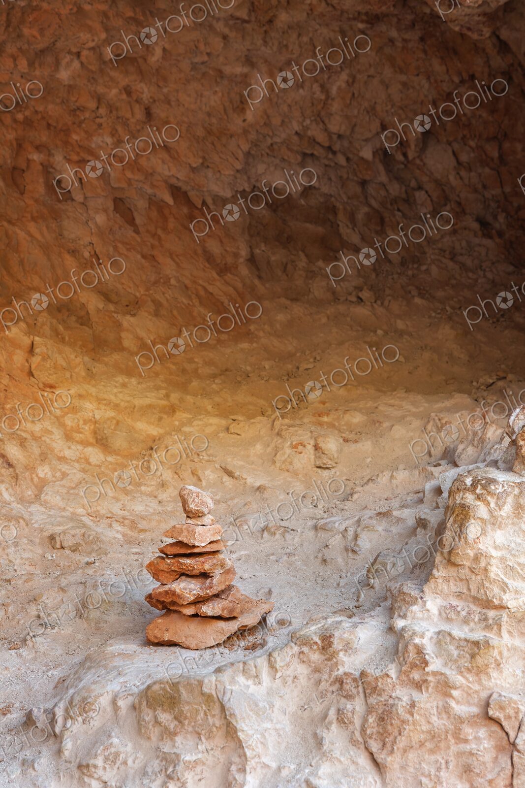 A balanced stack of red and orange sandstone rocks forms a small cairn in Bryce Canyon…