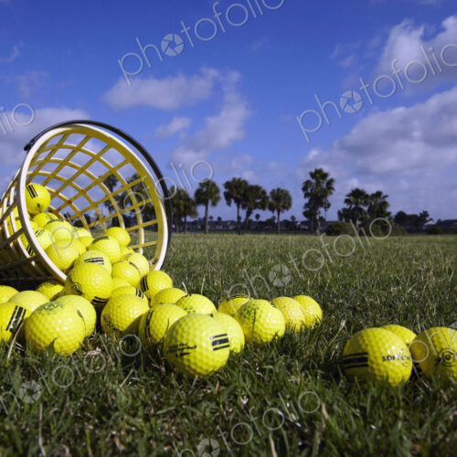 A basket of golf balls on a practise range A basket of golf balls on a practise range