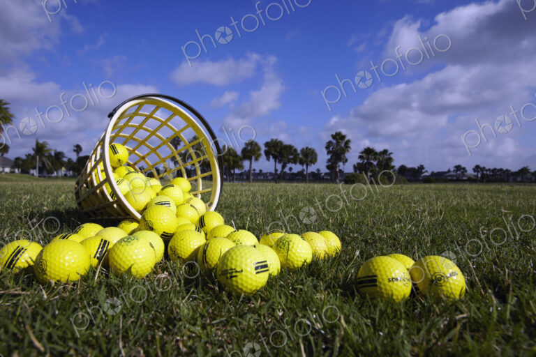 A basket of golf balls on a practise range