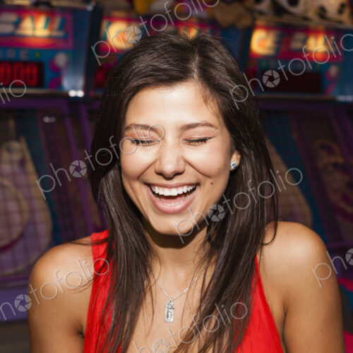 A beautiful young woman on the boardwalk in Atlantic City, in front of a row of slot… A beautiful young woman on the boardwalk in Atlantic City, in front of a row of slot…