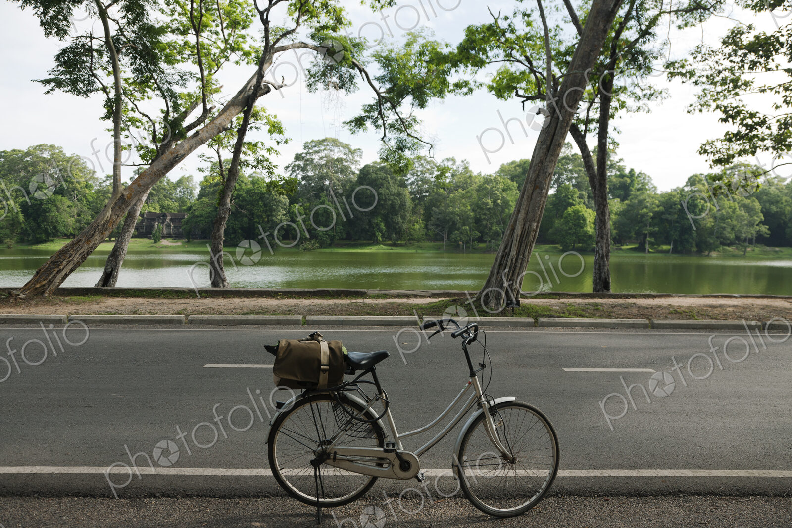 A bicycle with basket parked on the road to the Angkor Temples.