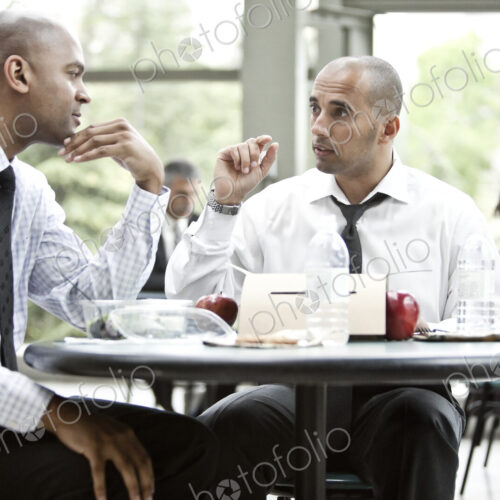 A black businessman and a middle eastern businessman having a business lunch. A black businessman and a middle eastern businessman having a business lunch.
