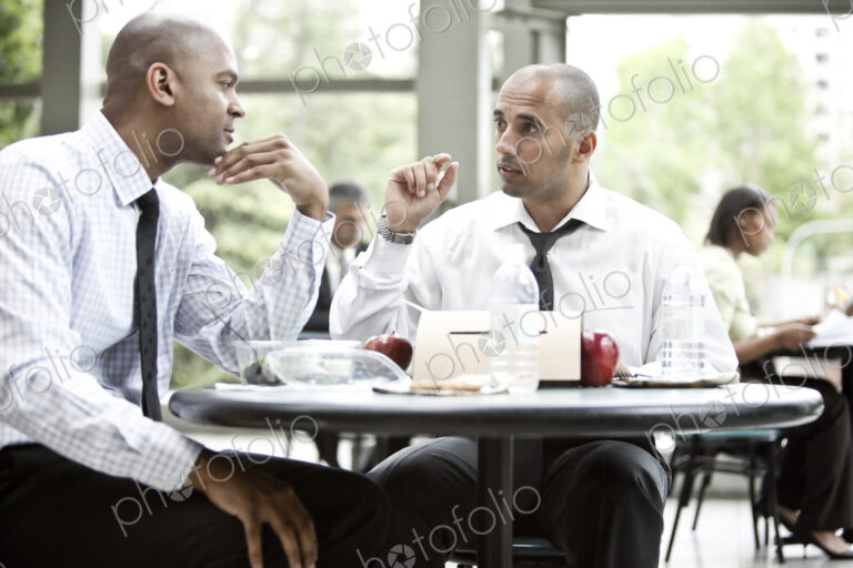 A black businessman and a middle eastern businessman having a business lunch.