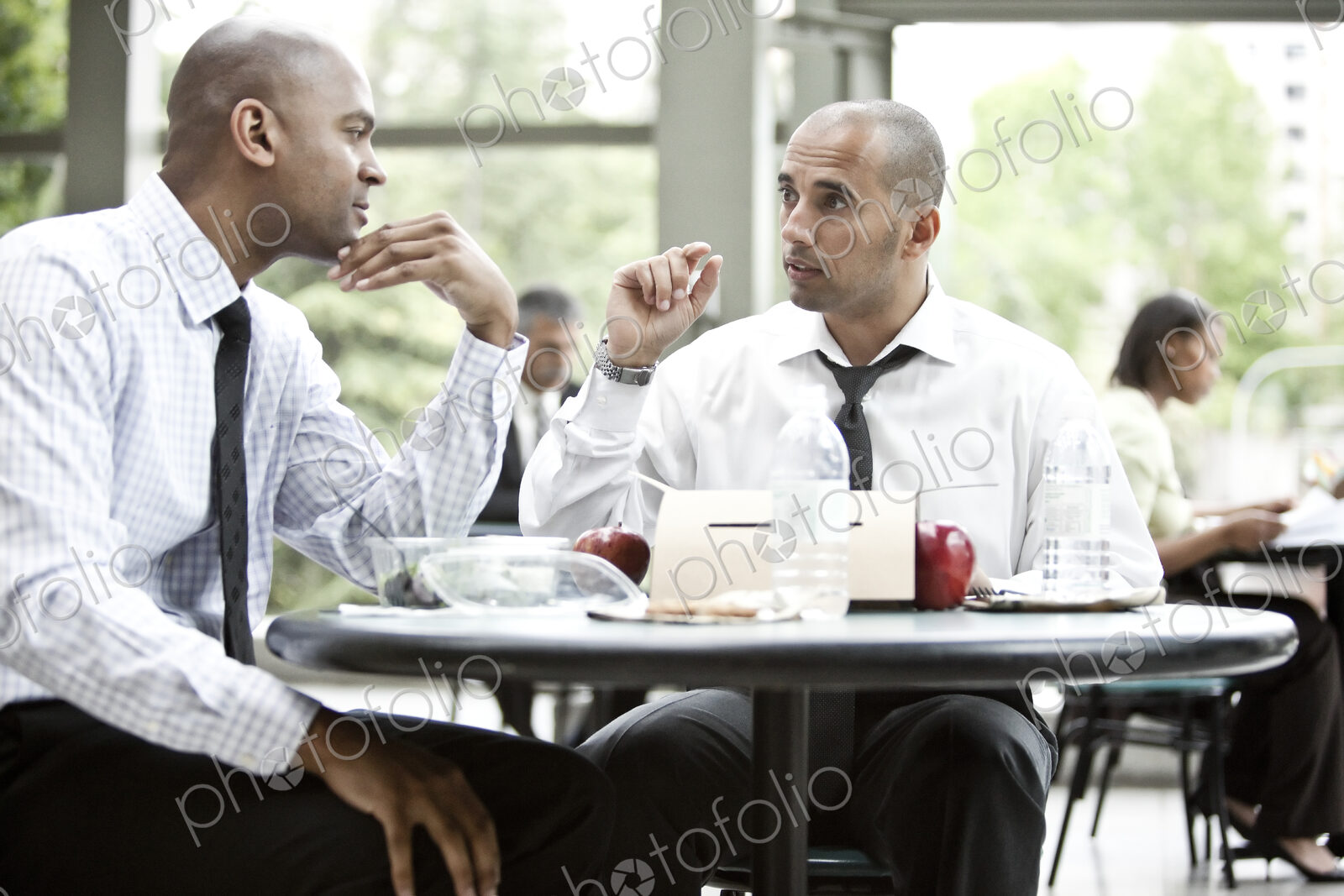 A black businessman and a middle eastern businessman having a business lunch.