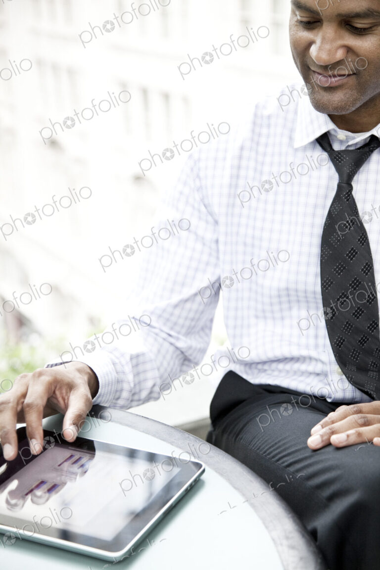 A black businessman working on a notebook computer..