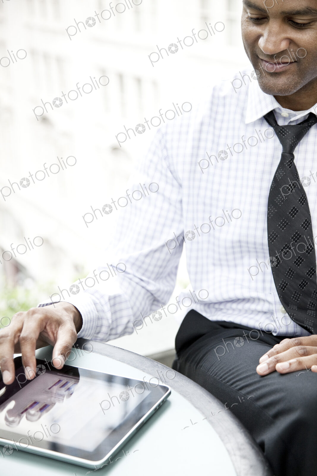 A black businessman working on a notebook computer..