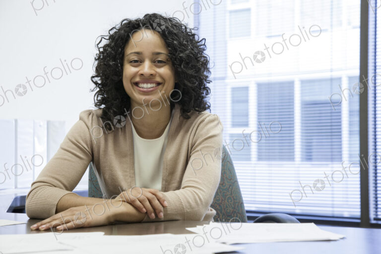 A black businesswoman at her desk in her office.