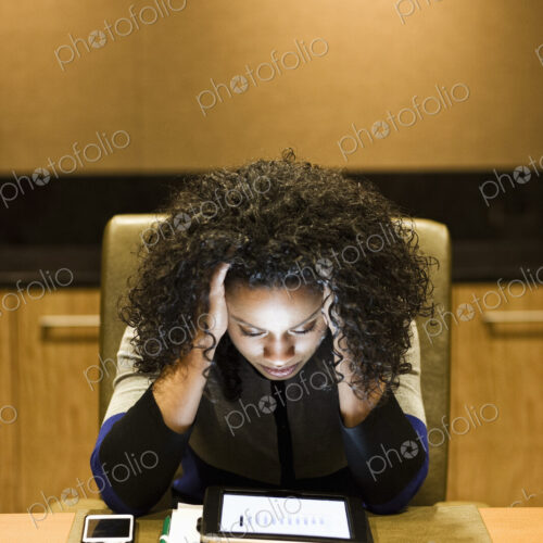 A black businesswoman looking intently at the screen of a notebook computer. A black businesswoman looking intently at the screen of a notebook computer.