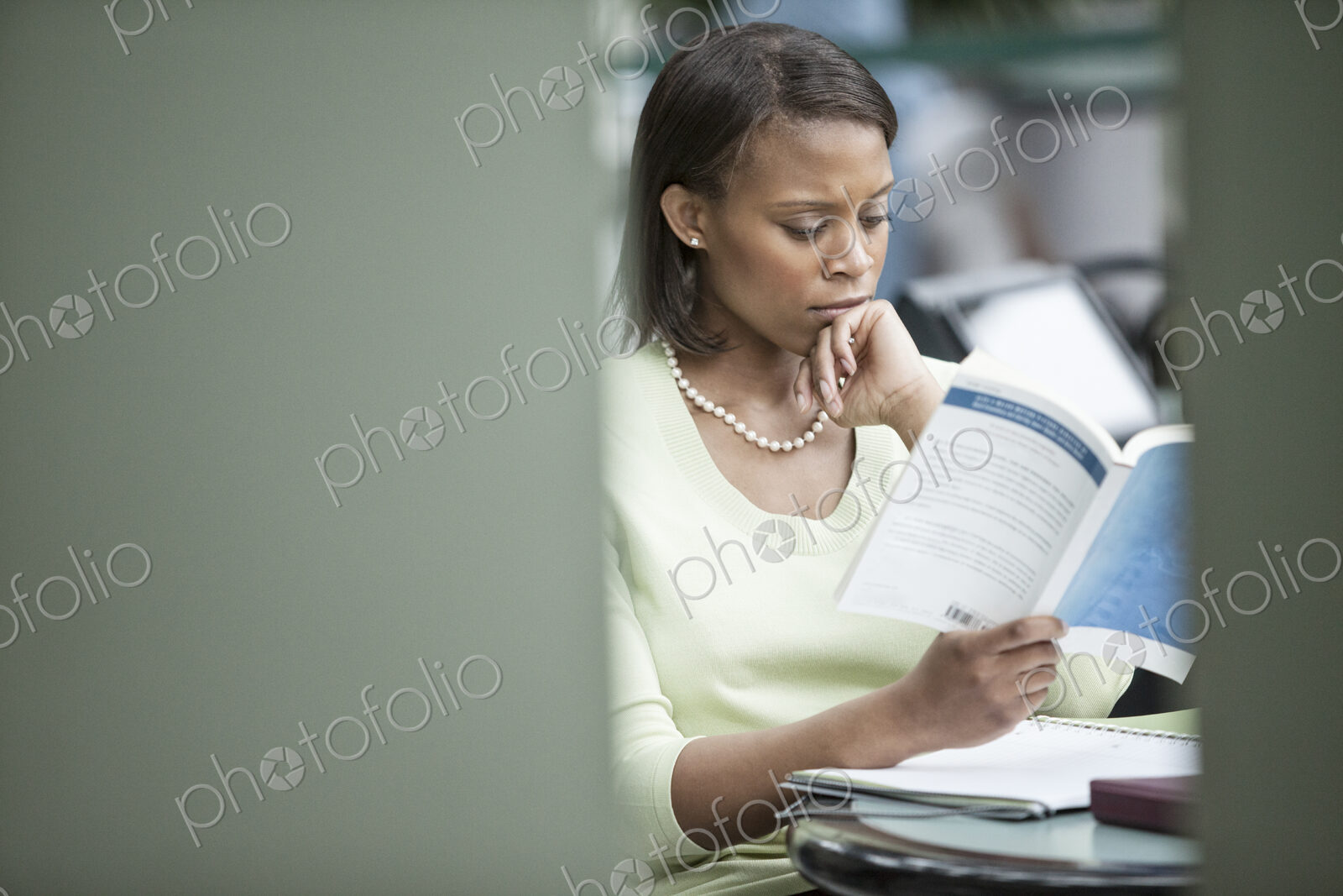 A black businesswoman reading a report.