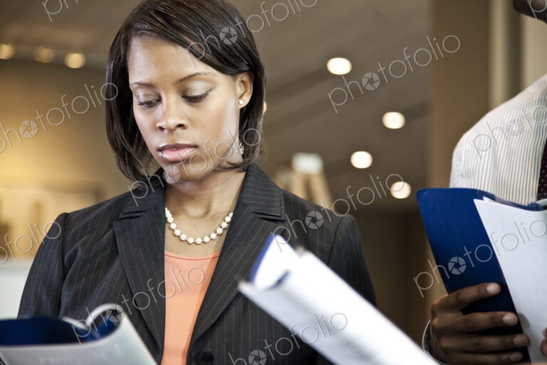 A black businesswoman reading a report.