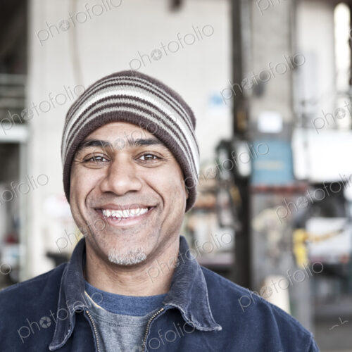 A black man factory worker in a sheet metal factory.