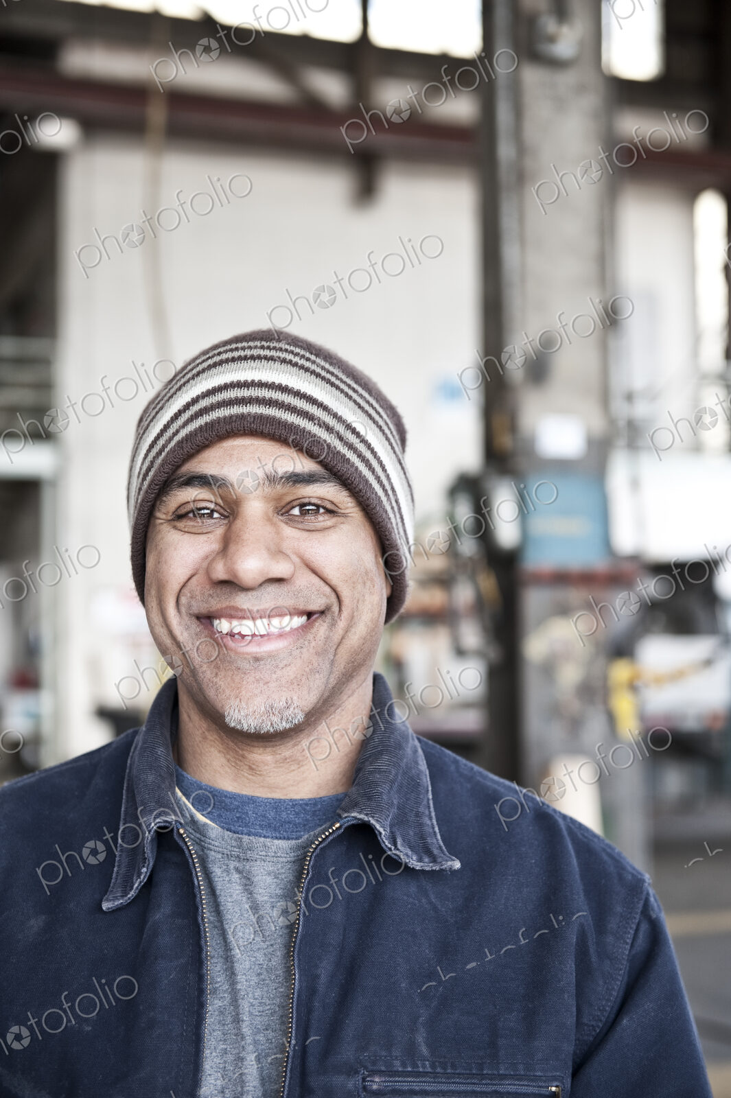 A black man factory worker in a sheet metal factory.