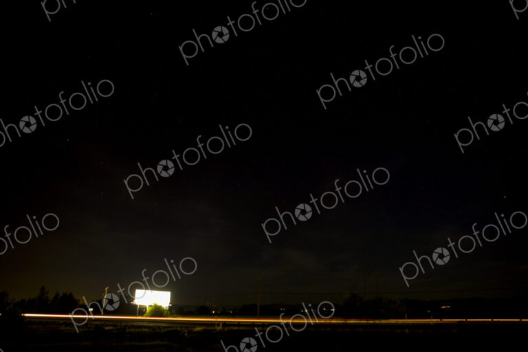 A black sky and a lit billboard along the Highway at Toppenish.