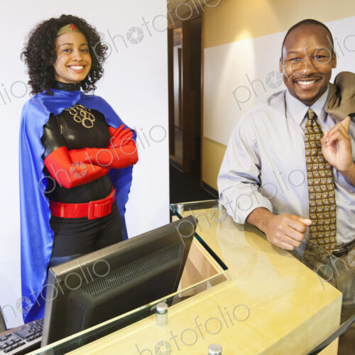 A blalck businessswoman office super hero and her black businessman partner in their… A blalck businessswoman office super hero and her black businessman partner in their…